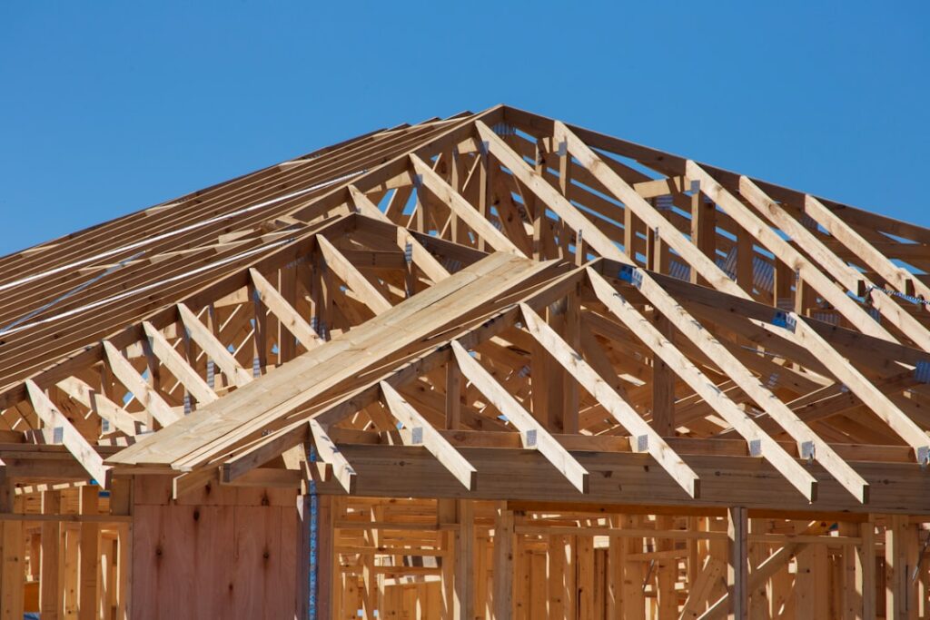 A homeowner and builder inspecting a newly built house interior during a walkthrough.