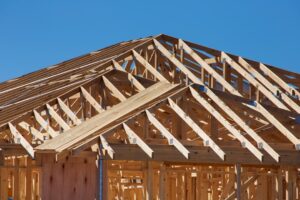 A homeowner and builder inspecting a newly built house interior during a walkthrough.