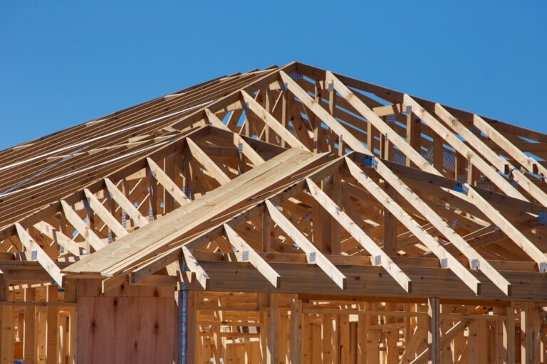 A homeowner and builder inspecting a newly built house interior during a walkthrough.